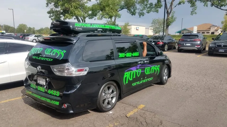 Black minivan with bright green custom vehicle graphics